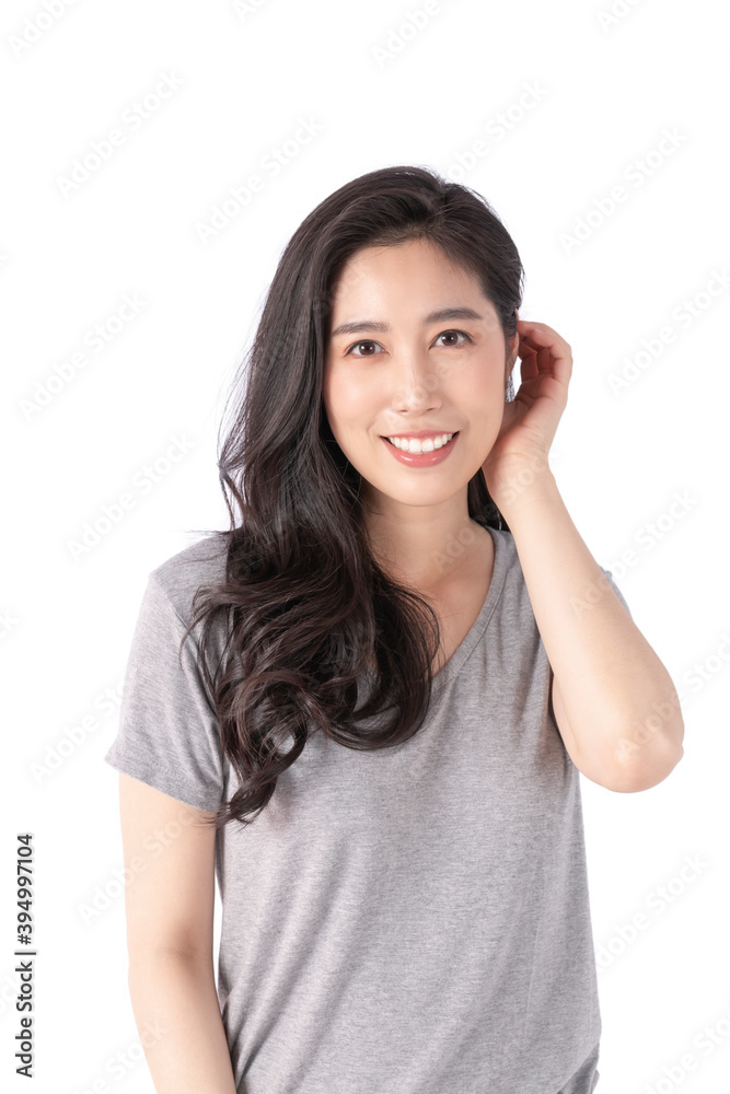 Happy cheerful young woman wearing gray t-shirt looking at camera with joyful and charming smile. Portrait of a pretty smiling woman posing isolated on a white background. Happy cheerful young woman wearing gray t-shirt looking at camera with joyful and charming smile. Portrait of a pretty smiling woman posing isolated on a white background.