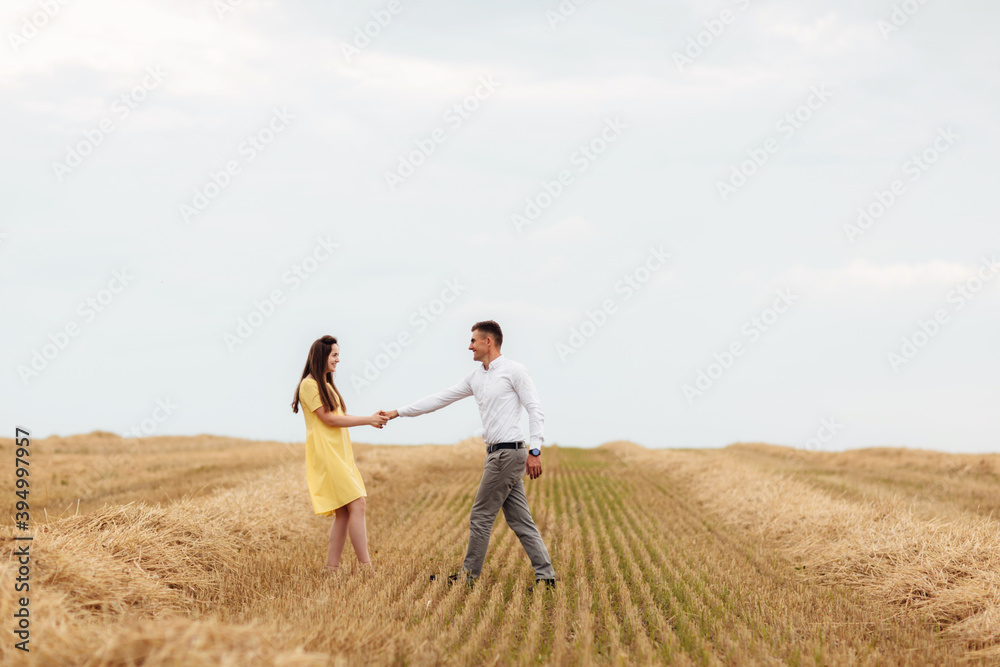 Happy young couple on straw, romantic people concept, beautiful landscape, summer season.