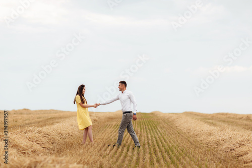 Happy young couple on straw, romantic people concept, beautiful landscape, summer season.