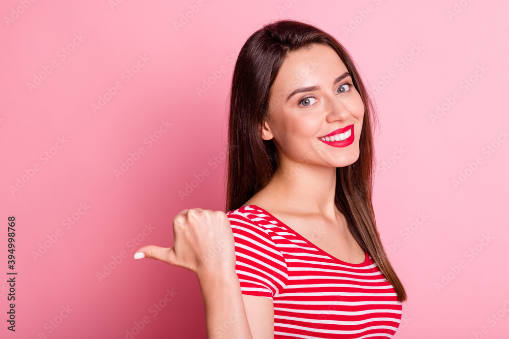 Close up portrait of delighted person indicate thumb empty space toothy smile isolated on pink color background Close up portrait of delighted person indicate thumb empty space toothy smile isolated on pink color background