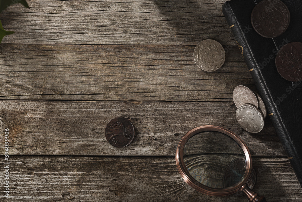 Numismatics. Old collectible coins on a wooden table. Top view. Numismatics. Old collectible coins on a wooden table. Top view.