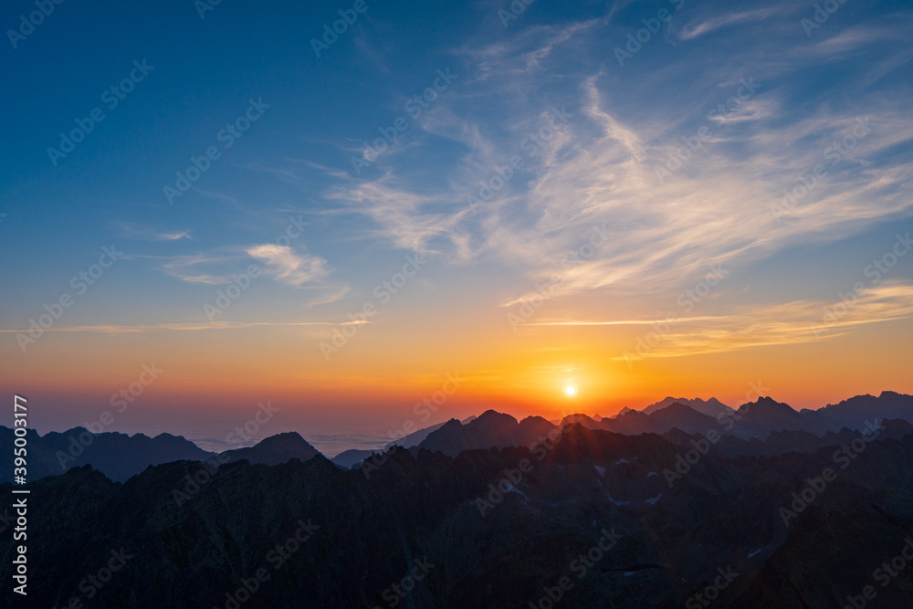 Panorama of early sunrise in the mountains. Summer clear sky with rising sun in the high Tatras in Slovakia. Nice scenery on top in Liptov region.