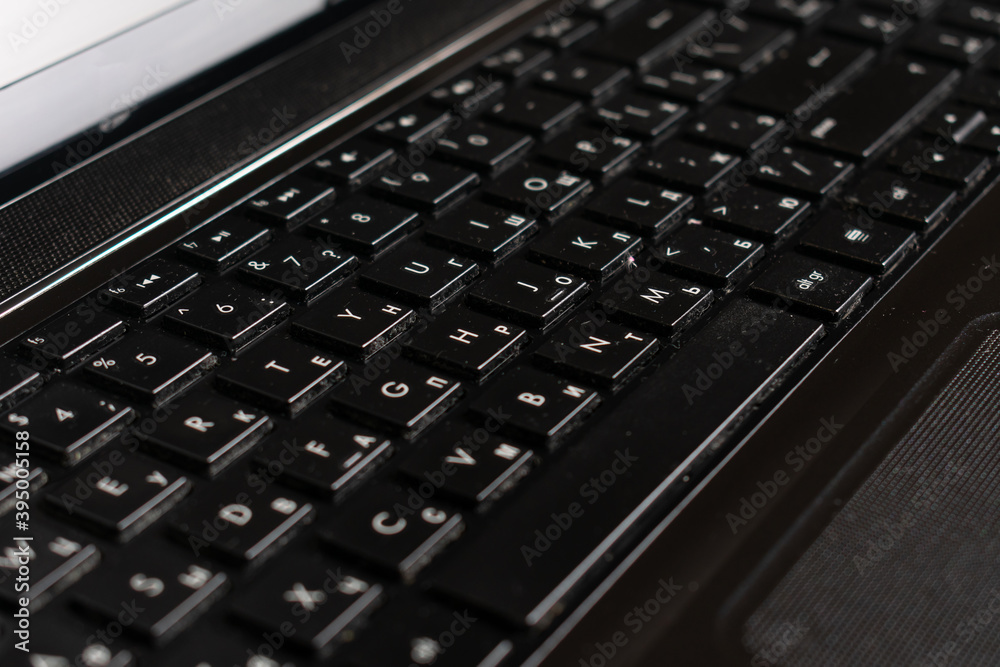 Black laptop and notepad on wood surface. Work space. 