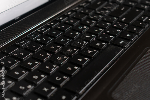 Black laptop and notepad on wood surface. Work space. 