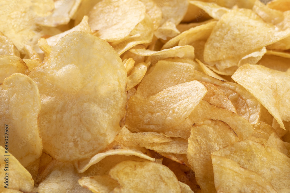 Crispy potato chips. Close-up. Background or banner of food. Crispy potato chips. Close-up. Background or banner of food.
