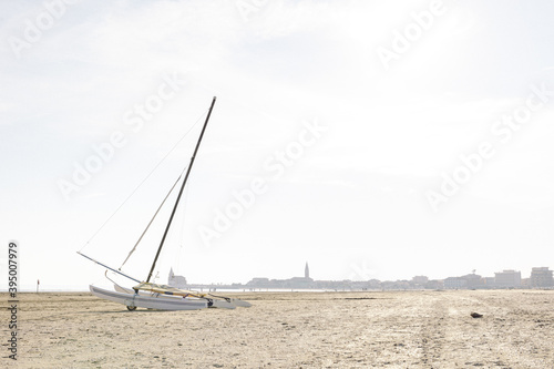 Abandoned sailboat with no sail on a beach in Italy