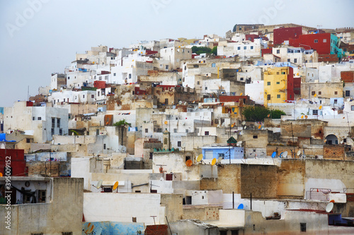 View of the colorful old buildings of Tetouan Medina quarter in Northern Morocco. A medina is typically walled, with many narrow and maze-like streets and often contain historical houses and places. © Renar