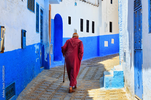 Unknown elderly man in Medina quarter in Chefchaouen, Morocco. The city, also known as Chaouen is noted for its buildings in shades of blue and that makes Chefchaouen very attractive to visitors. © Renar