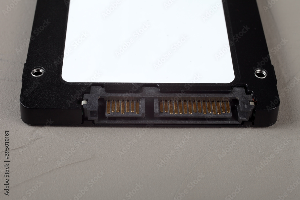 ssd hard drive on a concrete background, place for your text, close-up, selective focus. ssd hard drive on a concrete background, place for your text, close-up, selective focus.