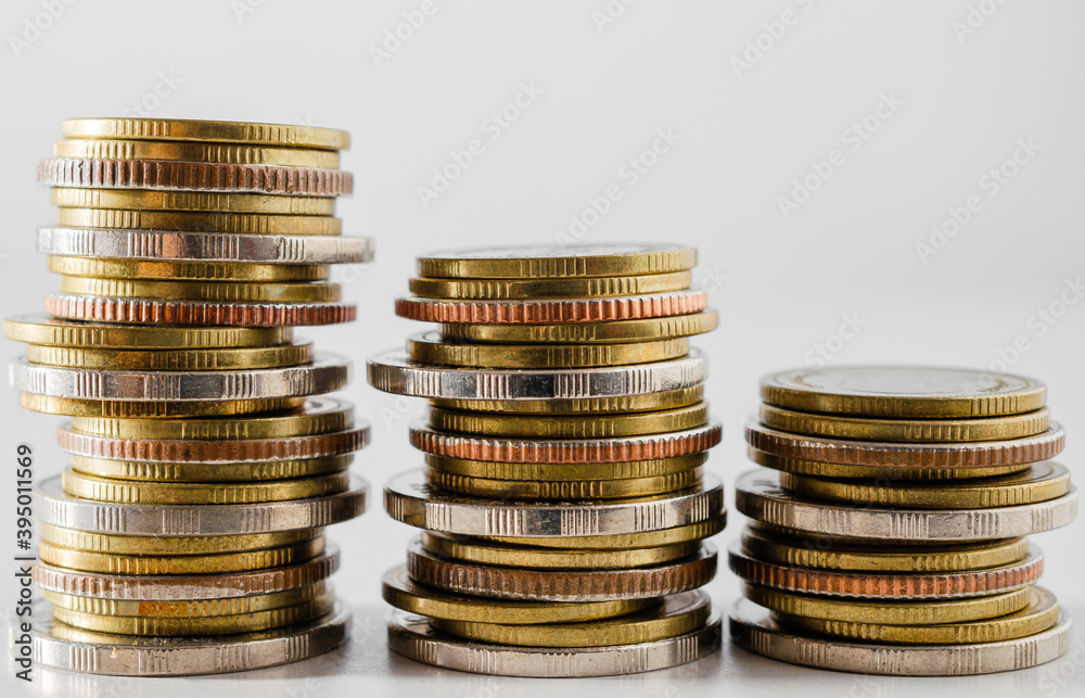 row of coin stack growing pile on white background for money saving and investment business financial and banking concept. row of coin stack growing pile on white background for money saving and investment business financial and banking concept.