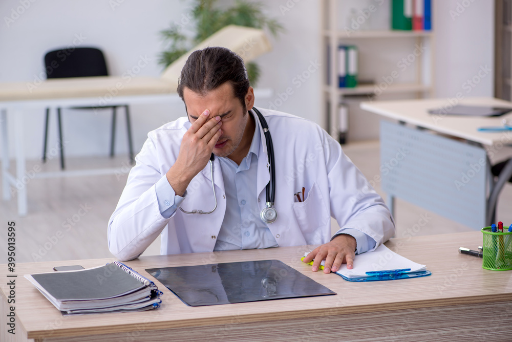 Young male doctor working in the clinic Young male doctor working in the clinic