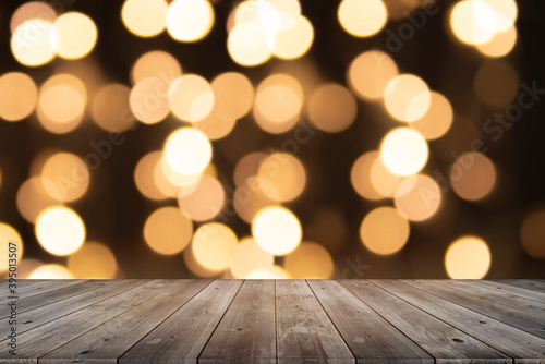 Old wooden table with the golden circle bokeh on black background. Abstract and blurred for texture and background.