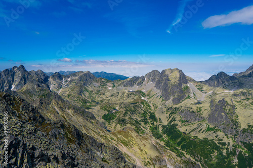 Mountain stone range peak against blue cloudy sky. Nature landscape. Travel background. National Park High Tatra  Slovakia  Europe.