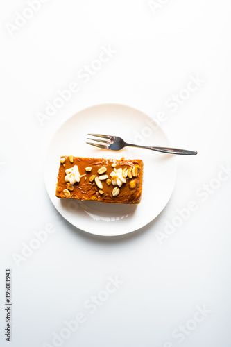 Tasty chocolate cake on white plate. Piece of cake on a plate isolated on white.
