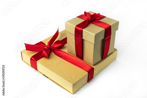 Holiday packaging, paper boxes with red ribbon . Isolated on a white background