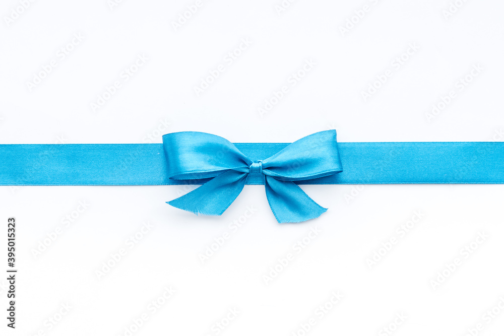 Blue ribbon with bow isolated on white. Top view, copy space Blue ribbon with bow isolated on white. Top view, copy space