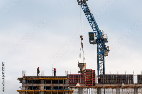 construction of a concrete building workers in helmets
