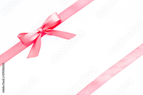 Pink ribbon with bow isolated on white for gift box. Top view, copy space © 9dreamstudio