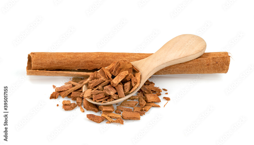 cinnamon broken and sticks with wooden spoon isolated on a white background cinnamon broken and sticks with wooden spoon isolated on a white background