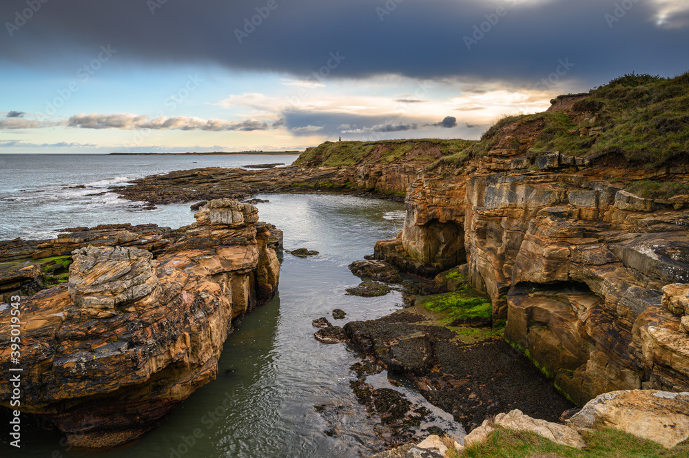 Cliffs and Coves at Rumbling Kern, on the rocky shoreline at Howick on the Northumberland coast, AONB, where there are several sandy coves