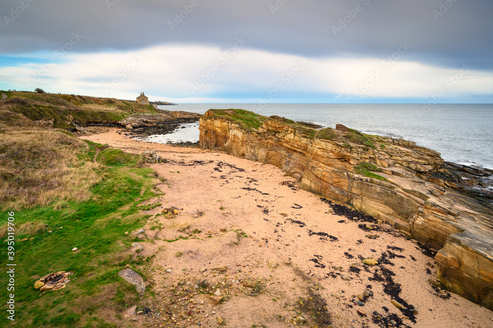 Rumbling Kern Beach from the Clifftop, on the rocky shoreline at Howick on the Northumberland coast, AONB, where there are several sandy coves
