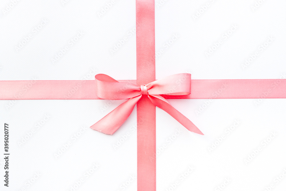 Pink ribbon with bow isolated on white for gift box. Top view, copy space Pink ribbon with bow isolated on white for gift box. Top view, copy space