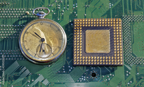 computer chip on circuit board and pocket watch photo