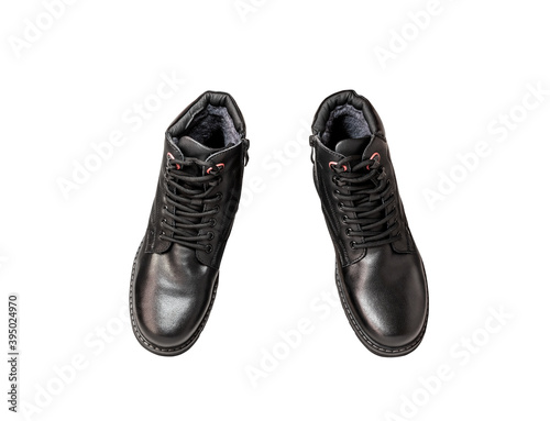Pair of black genuine leather boots. Men's clothing. Isolated over white background. View from above.