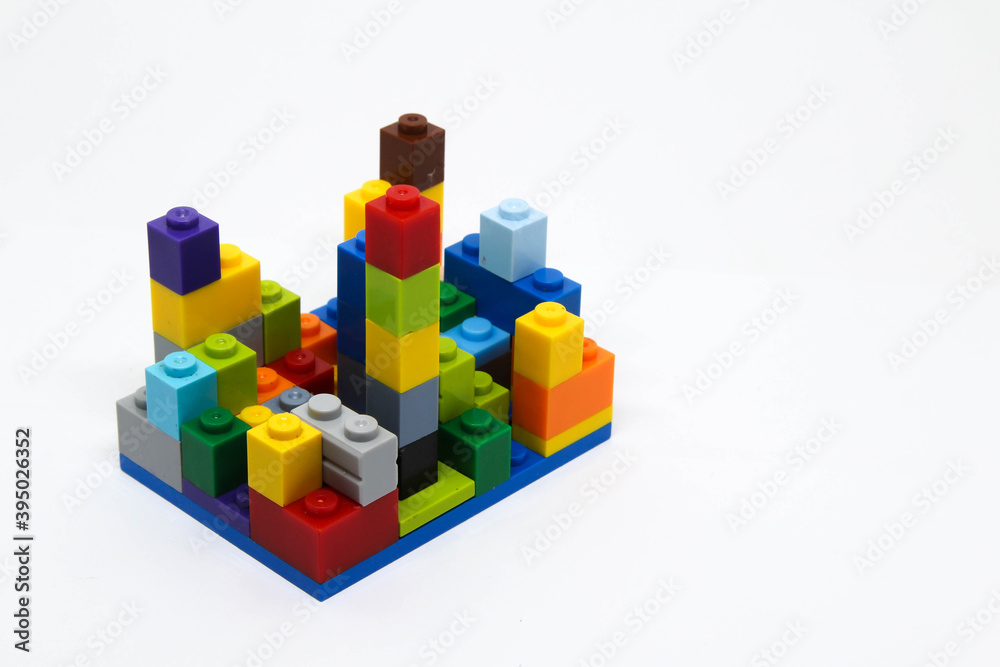 Colorful plastic building blocks isolated on white background.