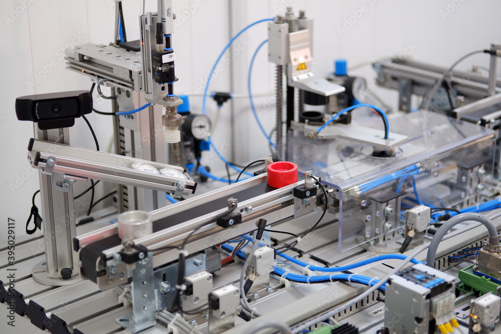 Industry 4.0 concept; artificial intelligence in smart factory. Close-up of product which is classified by sensors on assembly line equipped with sensors and pneumatic pieces of equipment. Industry 4.0 concept; artificial intelligence in smart factory. Close-up of product which is classified by sensors on assembly line equipped with sensors and pneumatic pieces of equipment.