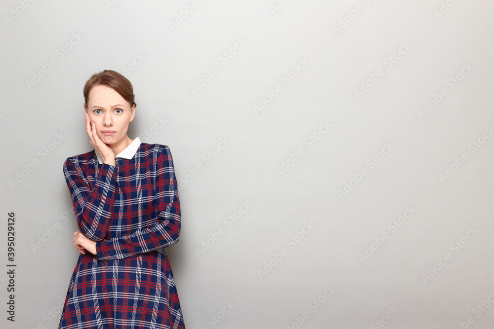 Portrait of unhappy shocked frightened girl touching cheek with hand Portrait of unhappy shocked frightened girl touching cheek with hand