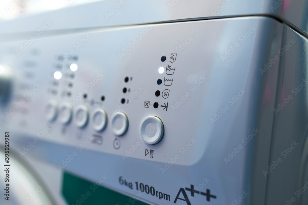 Working washing machine close up shot, focus on the icon's, shallow depth of field, copy space. Working washing machine close up shot, focus on the icon's, shallow depth of field, copy space.