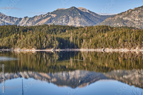 Reflecting mountain lake during sunset. Eibsee in the bavarian alps during sunset.