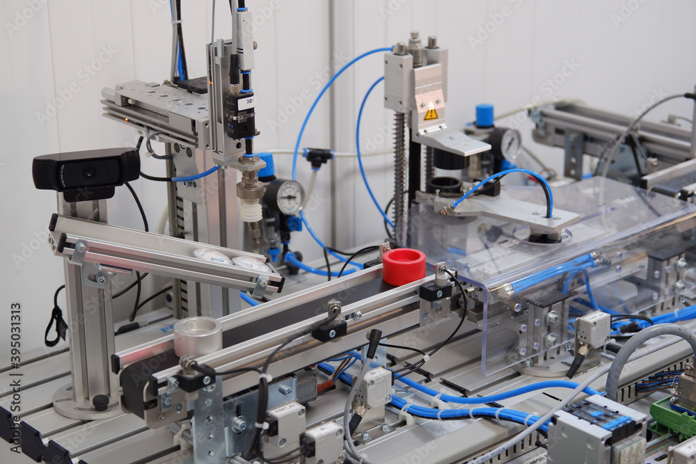 Industry 4.0 concept; artificial intelligence in smart factory. Close-up of product which is classified by sensors on assembly line equipped with sensors and pneumatic pieces of equipment. Industry 4.0 concept; artificial intelligence in smart factory. Close-up of product which is classified by sensors on assembly line equipped with sensors and pneumatic pieces of equipment.