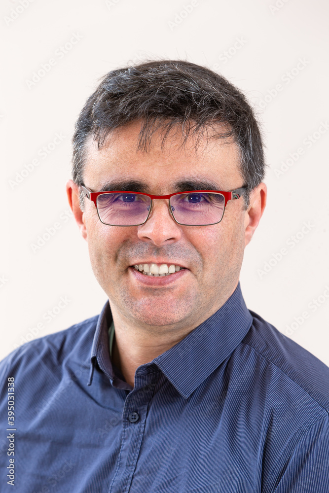 Portrait of handsome smart businesslike Financier or agent or manager in eyeglasses and bllue shirt