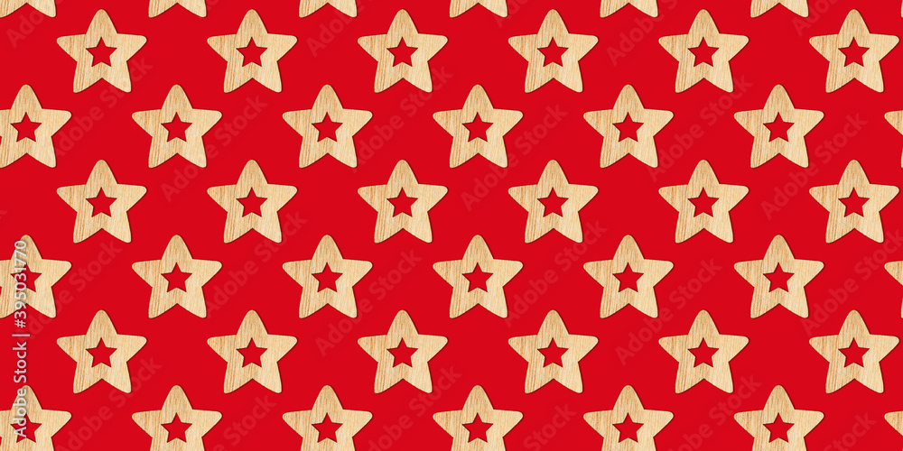 Seamless Christmas pattern with wooden decorative stars on a red background. Xmas abstract backdrop. Top view.