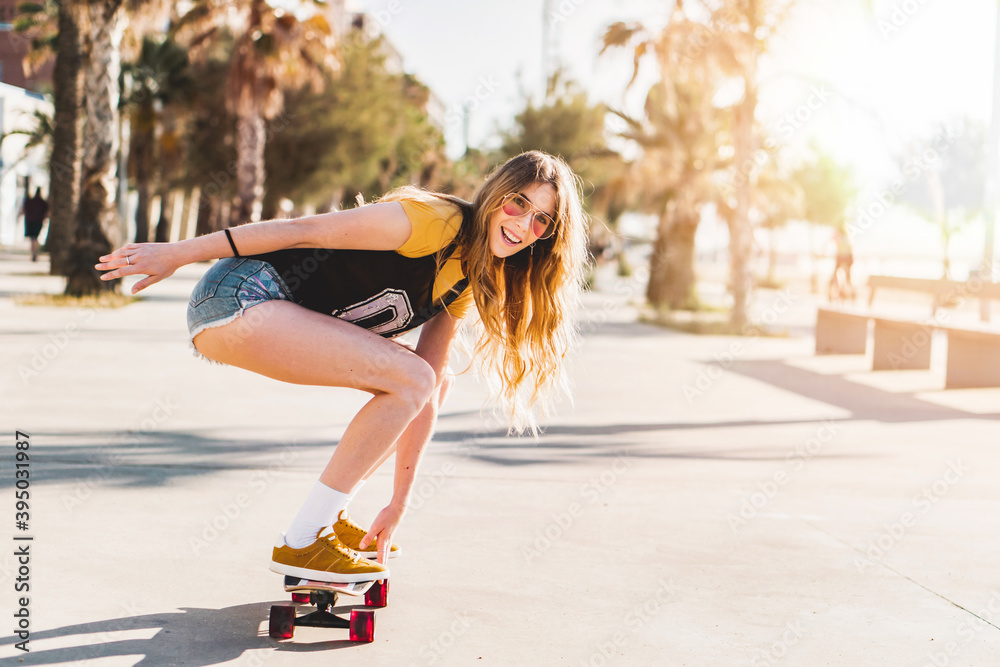 Skater girl riding a long board skate. Cool female urban sports. California  style outfit. Woman on skateboard wearing pink glasses Stock Photo | Adobe  Stock