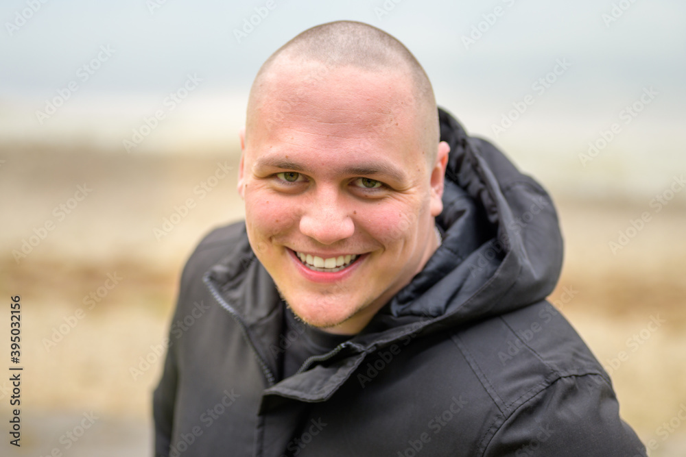 Friendly young man with a beaming warm smile Friendly young man with a beaming warm smile