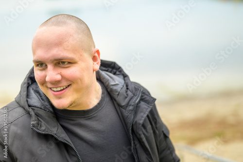 Young man looking down with a happy smile