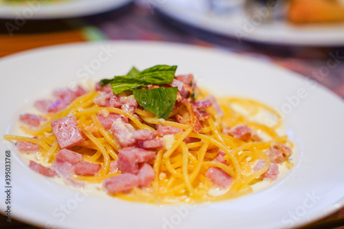 spaghetti carbonara with ham and parmesan cheese