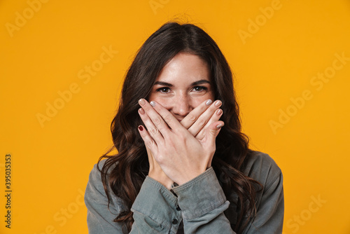 Happy beautiful girl posing and covering her mouth