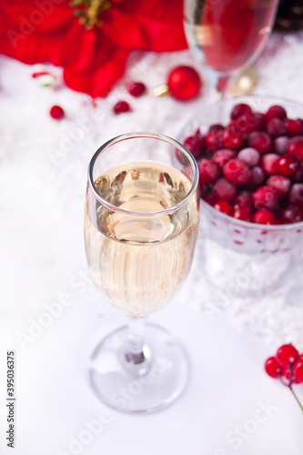 Champagne glass with cranberry and Christmas decoration. Christmas and New Year concept.
