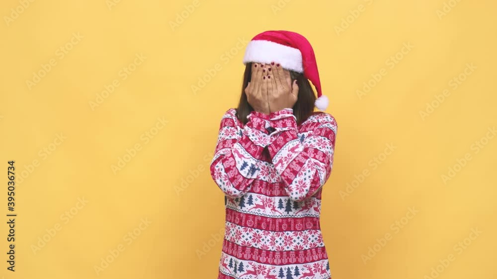 Young latin woman celebrating christmas day blink through fingers frightened and nervous Young latin woman celebrating christmas day blink through fingers frightened and nervous