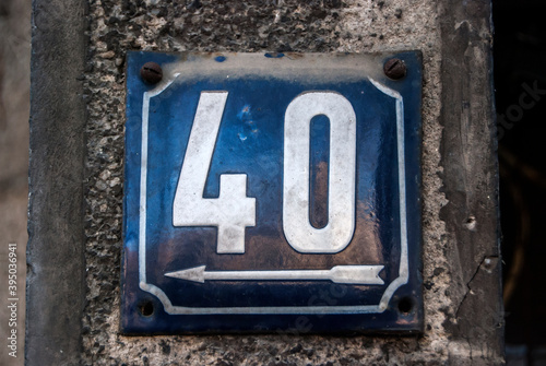 Weathered grunge square metal enameled plate of number of street address with number 40