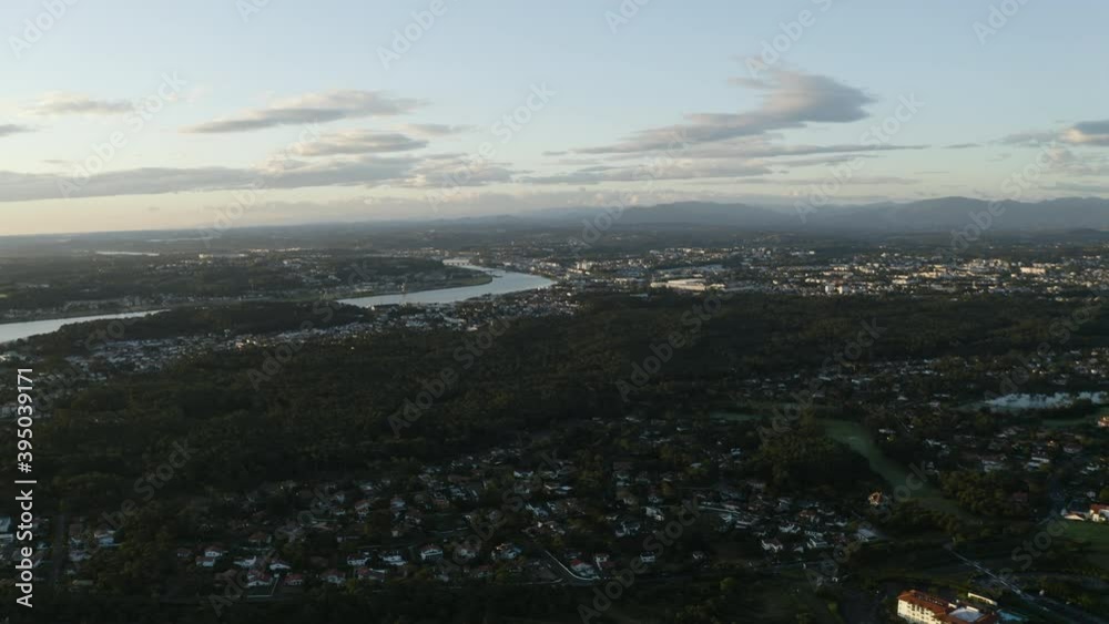 Early morning at the ocean, aerial shot of a beautiful sunrise with clouds. Located in Anglet. Surf country, Pays basque. Reflect of the sun in Adour river in southwestern France.