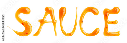 Word SAUCE from Chili sauce isolated on a white background. Close up, top view.