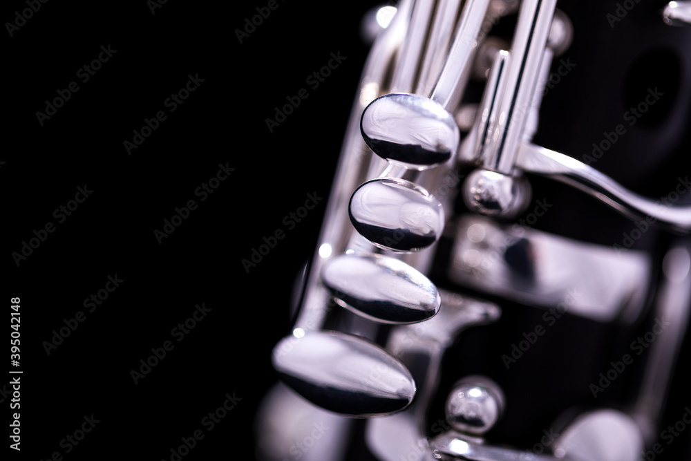 A new silver plated clarinet on a black background A new silver plated clarinet on a black background