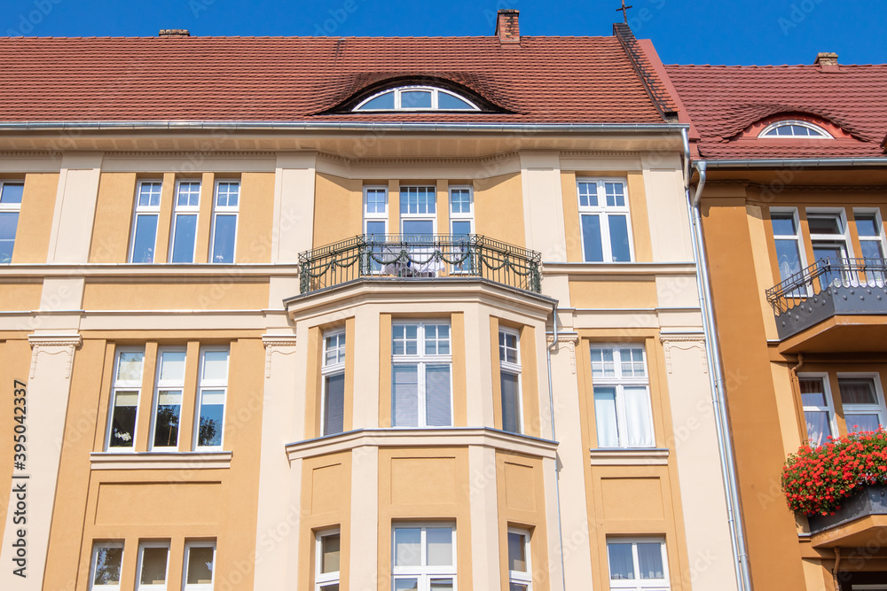 Fototapeta premium Old tenement houses on a background of blue sky