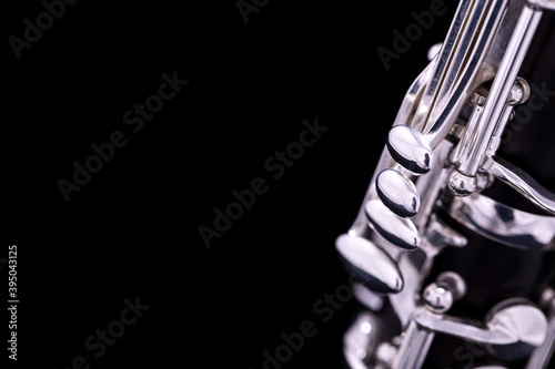 A new silver plated clarinet on a black background