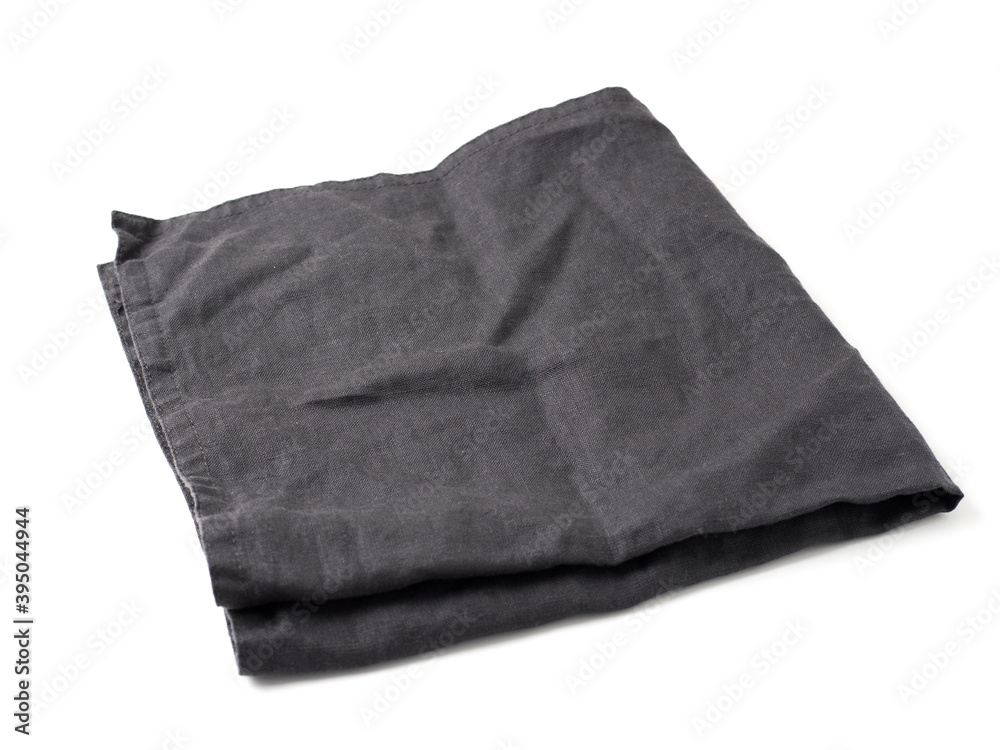 Side view on folded dark black linen napkin isolated on white background. Anthracite grey linen napkin. Isolated on white with clipping path. Side view on folded dark black linen napkin isolated on white background. Anthracite grey linen napkin. Isolated on white with clipping path.